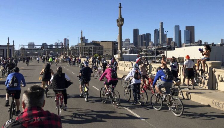 People ride across the 4th St. bridge on their bikes and other non-motorized forms of transportation for the car-free street 28th CicLAvia event in Los Angeles, Dec. 2, 2018. (AP Photo/Christopher Weber)
