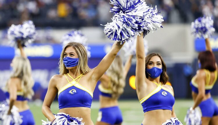 Cheerleaders wearing face masks perform prior to a preseason NFL football game between the Los Angeles Rams and the Los Angeles Chargers Saturday, Aug. 14, 2021, in Inglewood, Calif. (AP Photo/Ringo H.W. Chiu)