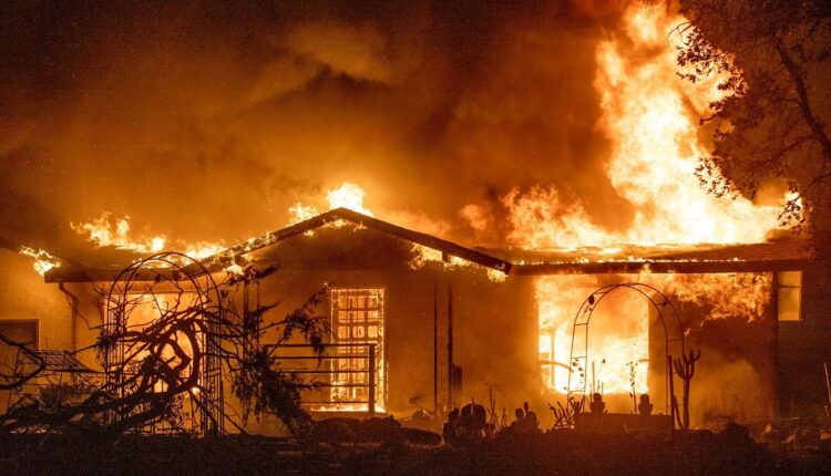 In this Sept. 27, 2020, file photo, a house burns on Platina Road at the Zogg Fire near Ono, Calif. Pacific Gas & Electric has been charged with manslaughter and other crimes in the Northern California wildfire that killed four people and destroyed hundreds of homes. (AP Photo/Ethan Swope, File)