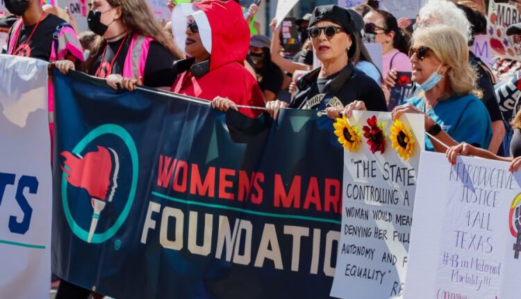 The+crowd+walks+toward+City+Hall+at+the+march+for+women%E2%80%99s+reproductive+rights+organized+by+Women%E2%80%99s+March+in+downtown+Los+Angeles%2C+Calif.%2C+on+Oct.+2%2C+2021.