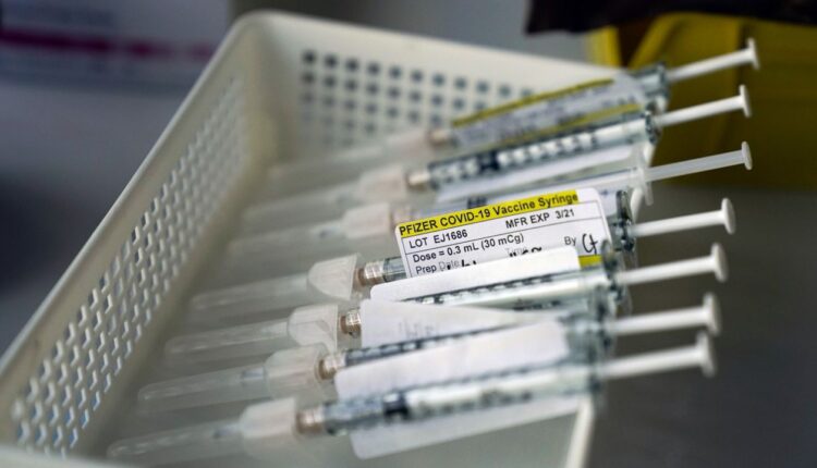 Syringes containing the Pfizer-BioNTech COVID-19 vaccine sit in a tray in a vaccination room at St. Joseph Hospital in Orange, Calif., Jan. 7, 2021. (AP Photo/Jae C. Hong) 