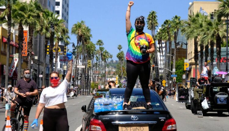 In this, June 14, 2020, file photo, protesters raise their fists at a march, organized by black LGBTQ leaders in Los Angeles. (AP Photo/Paula Munoz)
