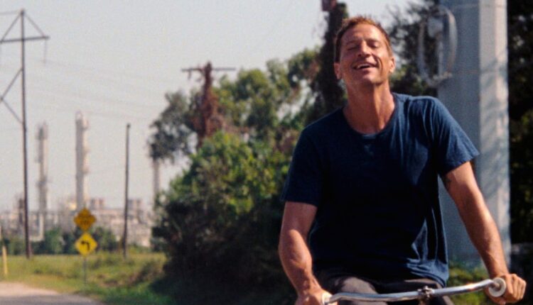 Simon Rex rides a bike through Texas City in "Red Rocket"