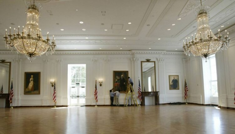 Workers put the finishing touches on the new life-size replica of the White House East Room, at The Nixon Library and Birthplace in Yorba Linda, Calif., Aug. 11, 2004. (AP Photo/Nick Ut)