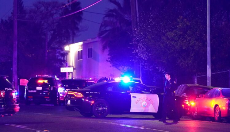 Law enforcement vehicles from several agencies block a street near the scene of a shooting in Sacramento, Calif., Monday, Feb. 28, 2022. (AP Photo/Rich Pedroncelli)