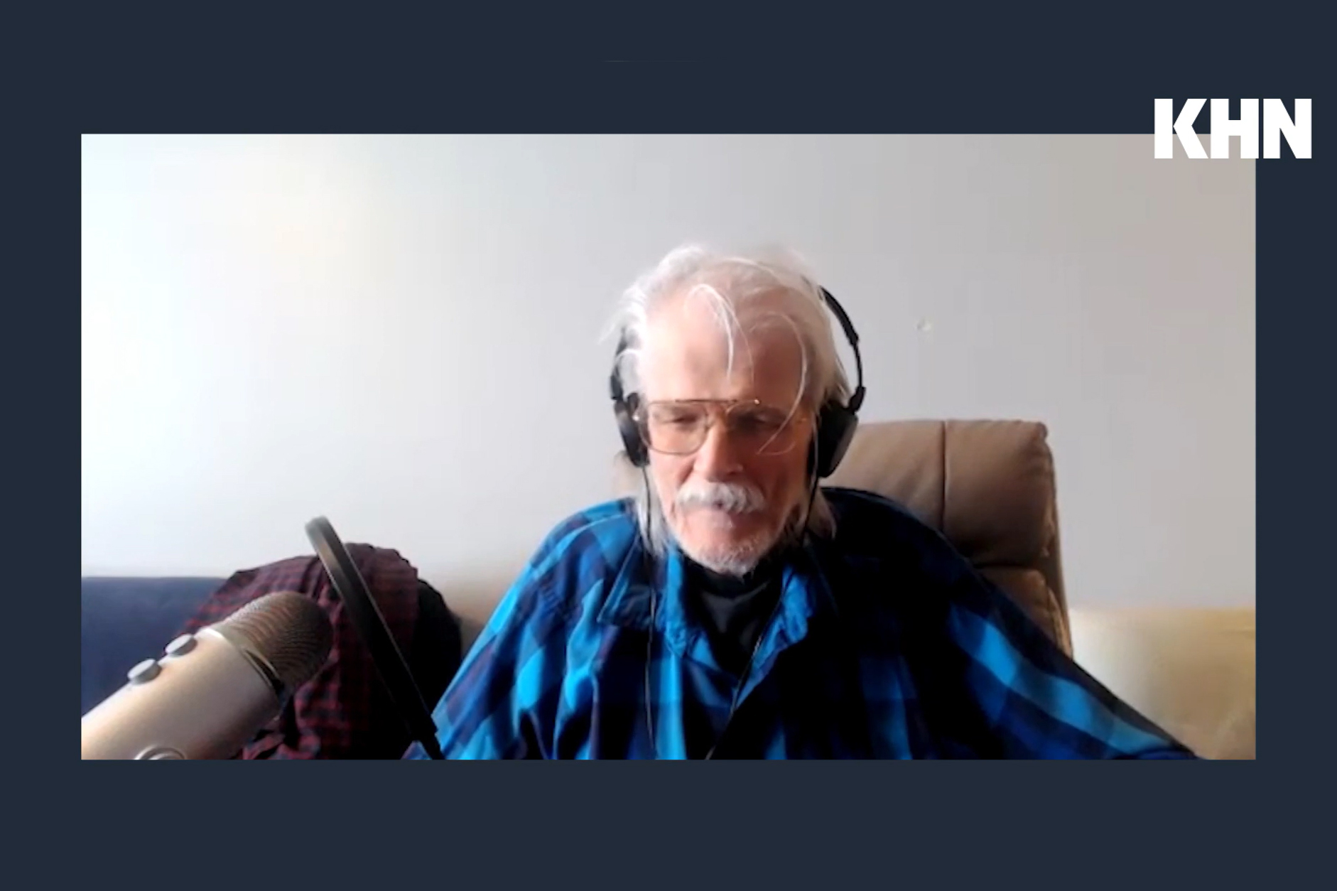 A screenshot of a video shows Terry Bell sitting with a microphone next to him. The KHN logo is superimposed on the top right of the image.