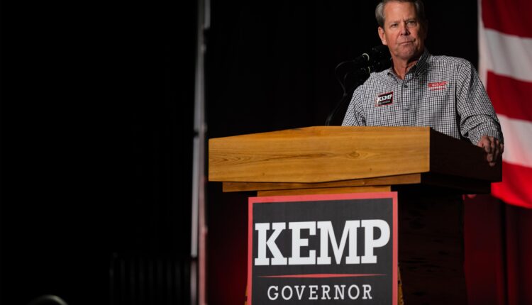 A photo shows Gov. Brian Kemp speaking at a rally.